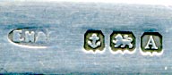 This bookmark, a 'Jersey' souvenir, was made in Birmingham England in 1925 by E Horton & Co. It is a George V English sterling silver bookmark with an enamel coat of arms on a three point cross above a ball.