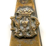 This bookmark was made in France as a souvenir for Our Lady of Lourdes, depicted as the finial on the top. It is brass with warn silver plating. The Lourdes shield is highlighted above.