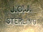This is an older signed silver book mark with tamp work and blue turquoise stone in a serrated bezel. Marked on the back JCJ and STERLING, made by Isleta Pueblo silversmith Joann Christine Juancho.