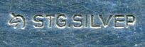 This bookmark is shaped like a boomerang with an enamel figural of Australia on the top. Within the figure is a kangaroo and an emu holding a shield. The back is marked stg silver with a unicorn mark.