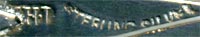 This bookmark was made (most probably in England). It is marked WH.I and Sterling Silver. It is in the shape of a trowel with blue agate pieces in the handle.
