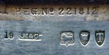 This bookmark is made in London, England. The manufacturer's mark is S.M. & Co. for Sampson Mordan & Co. The top is a magnifying glass and has a place for a tiny book (which unfortunately is missing). The date is 1894.