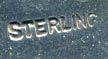 This bookmark was made in the US by an unknown manufacturer. It is marked sterling on the back. The top is a flower in full bloom.