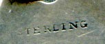 This bookmark was made in the US by an unknown manufacturer. The top blade, in the shape of a leaf is inscribed LPW. The very top has leaves and a crown.