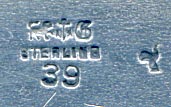 This is an American made bookmark. The manufacturer is Gorham. It is marked with the manufacturers hallmark, Sterling and the catalog number 39.  The top has an acorn design. It's nicely detailed. It is from the Autumn 1888 Gorham Catalog (although the date mark on this particular bookmark is from 1890). It is one of 33 different bookmarks offered that year.