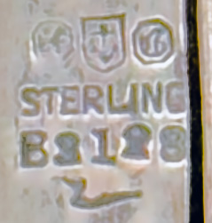 This is an American made bookmark. The manufacturer is Gorham. It is marked with the manufacturers hallmark, Sterling and the catalog number B3128. The top is an art nouveau cutout design. The date is 1900 - 1920.