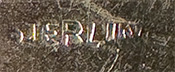 This bookmark was made in the US by an unknown manufacturer. The top is a figural of two trees. The blade says Bickelmann Schenectady.
