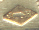 This bookmark was made in France. It is marked on the top blade and on the back of the bottom blade with a lozenge. Inside the lozenge are the letters J and H separated by some kind of animal. The top blade looks to be either gold plate or brass with enamel fleur de lis'. The longer bottom blade looks to be rose gold in color but the metal is unknown. The top is a fleur de lis.