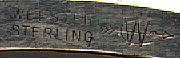 This bookmark was made in the US by Webster sometime between 1910 - 1930. It is marked Webster Sterling with the manufacturers hallmark. The shape of this bookmark has been used on a number of bookmarks with different tops. This one has an enamel picture of a rose. The other ones in this collection with this shape are #74 and #134.