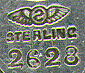 This bookmark was made in the US by George W. Shiebler & Co. It is marked with the makers hallmark, sterling and the number 2628. The top is an art nouveau design. The date is 1891 - 1910.