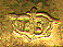 This bookmark was made in the US by an unknown manufacturer. It is marked TB on the back. It is made of bronze d'ore and enamel in two pieces separated by a red, white and blue silk ribbon. One part of the bookmark is an enameled eagle and the other side is a blade with a figural eagle on top. The date is 1920 - 1940.  