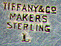 This bookmark was made in the US by Tiffany and Co. It is marked Tiffany and Co. Sterling Makers and the letter L. The top is a figural heart. The date is 1930 - 1940.  