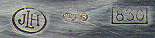 This bookmark was made in Sweden. It is marked JLH, the Swedish import marks and 830. The top is a figure of an owl. The date is 1920 - 1930.  