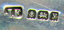 This bookmark was made in Birmingham, England. It is marked with the hallmarks for that city and the date mark for 1923. It is in the shape of a trowel with  multi-colored agates.