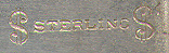 This bookmark was made in the US by Watson Company. It is marked Sterling with a dollar sign on each end. The top has a relief image of a tulip. The date is 1900 - 1910.