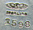 This bookmark was made in the US by Shiebler. It is marked with the makers hallmark, sterling and the number 2598. The top is a figural of two birds. The date is 1900 - 1910.