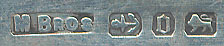  This bookmark was made in Birmingham, England by Mitchell Brothers. It is marked with the manufacturers mark, and the hallmarks for Birmingham and the date of 1888. It is in the shape of a sword with a mother of pearl handle and a chain.  