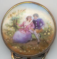  This bookmark was made in Europe, possibly France. The top is a hand painted porcelain medallion with a couple in 18th century garb. It is a brass bookmark with a dore finish. The date is 1870 - 1900.  