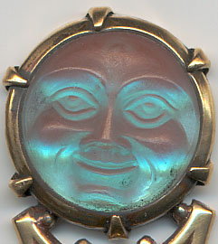  This bookmark was made in Europe, possibly France. The top is a medallion made of saphiret glass in the shape of a moon face caricature. It is a brass bookmark with a dore finish. 