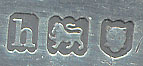  This bookmark was made in London, England. It is marked with English hallmarks for London and the year 1903. The bookmark is a figure of the character Portia, robed as a judge from the Shakespeare play "The Merchant of Venice." Inscribed on the back is a quote from the play, "The quality of mercy is not strained." 