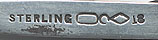 This bookmark was made in the US by Dominick and Haff, Inc. between 1889 and 1910. It is marked with the manufacturers hallmark, sterling and the number 18. The smaller top blade has an art nouveau design .