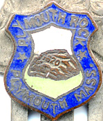  This bookmark was made in the US as a souvenir for Plymouth Rock. It is made of brass in the shape of an Indian head. Under the head is a shield in enamel with a picture of Plymouth Rock. The date is 1940 - 1950.  