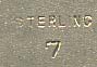  This bookmark was made in the US by William Kerr. It is marked sterling 7 on the back. The top is the face of a cherub and the entire bookmark is finished in a gold wash. The date is 1900 - 1910.     