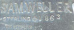  This bookmark was made in the US by J. F. Fradley & Co., a small New York silver manufacturer in business from 1870 - 1936. It is in the shape of a man, Sam Weller, the servant of Samuel Pickwick from the book The Pickwick Papers by Charles Dickens. It is marked Sterling, the cross hallmark, 1863 and The Metcalf Co. Also inscribed on the back is "Sam Weller". Date is 1890 - 1936.      