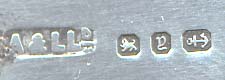  This bookmark was made in Birmingham England by Addie and Lovekin. It is marked with the makers symbol and the marks for Birmingham and 1898. It is in the shape of a trowel with a turned ivory handle. The very tip of the trowel blade is also marked with a very small symbol, possibly masonic.  The date is 1898.   