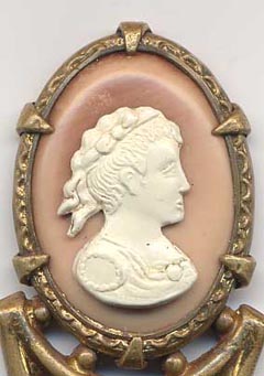  This bookmark was made in France. It is unmarked gilded brass and has a cameo on top. The date is 1890 - 1910.  
