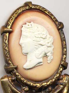 This bookmark was made in France. It is unmarked gilded brass and has a cameo on top. The date is 1890 - 1910.  