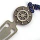 This bookmark has a blue tassel and a ship's wheel design at the top. It is marked Inman Sterling on the back. I don't know when it was manufactured.