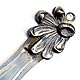 This bookmark was made in the US by an unknown manufacturer. It is marked 925/1000 sterling. The top is a figure of a partial flower with some petals missing (on purpose).  The date is 1900 - 1910.