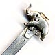 This bookmark was made in the US by an unknown manufacturer. It is marked sterling. The top is a figural elephant, walking with trunk upturned.  The date is 1930 - 1950.