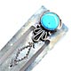 This bookmark is made in the US by a native American tribe. It has a turquoise stone on the top and is marked Many goats, sterling on the back.