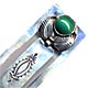 This bookmark is made in the US by a native American tribe. It has a green stone on the top and is marked Many goats, sterling on the back.
