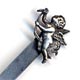 This bookmark has a cherub or angel with wings spread as the top blade. It is marked sterling on the back. The manufacturer is unknown.