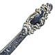 This bookmark was made in the US by an unknown manufacturer. It is marked sterling on the small blade on the back. It is in the shape of a sword with an art nouveau design on top. The blade is inscribed "Anna."