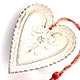 This bookmark was made in the US by an unknown manufacturer. It is in the shape of a heart with an inscribed design on the inner blade. The back is marked sterling and has the inscription "E.H. Sep. 10 '98". A red tassel is attached at the top.
