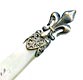 This silver plate and mother of pearl bookmark was made in France. The top has a fleur-de-lis and the the inscription on the top blade reads Amboise.