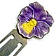 This bookmark was made in the US by F.A. Hermann Co. It is marked sterling and has half of a hallmark on the top back. The top is an enamel pansy flower in purple and yellow. 