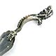 This bookmark was made in China and is hallmarked with Chinese symbols. It is in the shape of a trowel with a dragon as the handle.