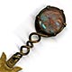 This bookmark was made in Europe, possibly France. The top is a medallion made of saphiret glass in the shape of a moon face caricature. It is a brass bookmark with a dorè finish. The date is 1870 - 1900. 