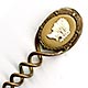 his bookmark was made in France. It is unmarked gilded brass and has a cameo on top. The date is 1890 - 1910.