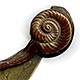 This bookmark is made in Japan between 1890 - 1910. It is made of brass and bronze with a figural snail as the top blade. It is also a clip where you can squeeze the shell part of the snail to raise the body to slip the page between.