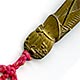 This bookmark is made in Japan between 1890 - 1910. The top has a basket with a crab climbing up and a red silk string.