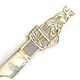 This bookmark was probably produced in France. It is made of mother-of-pearl and has a hand carved figural female maid holding a broom . The date is 1880 - 1900.