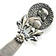 This bookmark was made in France. The top has a medallion with the head of Joan D'Arc. It is held up by two fleur-de-lis'. The top blade also has a fleur-de-lis.