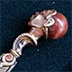 This brass bookmark was made in France by an unknown manufacturer. It depicts the head of an African warrior with diamond eyes and an agate marble head. It has the remnants of a bronze finish.