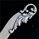 This bookmark was made in the US by Gorham. It is a small bookmark or letter opener with one blade. The top has a floral design.